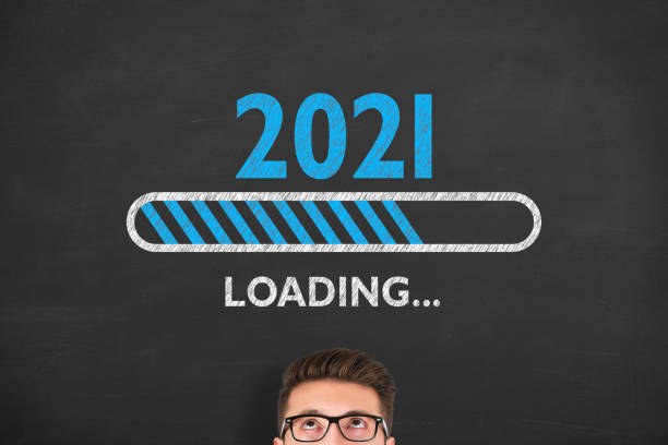 istock Human Hand Drawing Loading New Year 2021 over Human Head on Chalkboard Background 1288480302