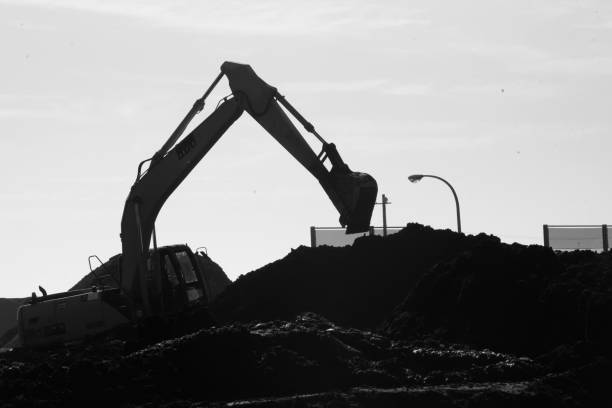 istock Silhouette image of Crane excavator at a construction site. 1288480511