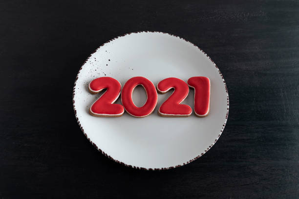 istock Numbers 2021 from gingerbread 2021 on white plate, top view. New year concept 1288480988