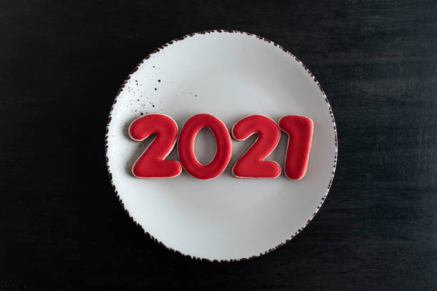 istock Numbers 2021 on white plate, top view. 2021 new year from gingerbread 1288481006