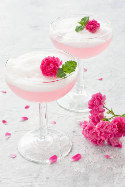 Pink cocktail with rose flowers stock photo