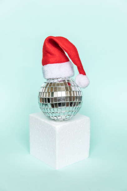 istock Simply minimal composition disco ball in Santa hat and cube shapes geometric form podium isolated blue pastel background. Christmas New Year december time for celebration concept. Mockup, copy space 1288482775