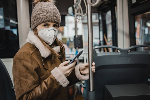 istock A woman with a face mask on public transportation 1288483867