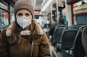 Portrait of a woman with a face mask on public transportation