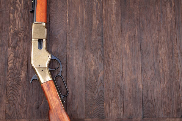 istock Old west gun - lever-action repeating rifles with ammunition 1288485763