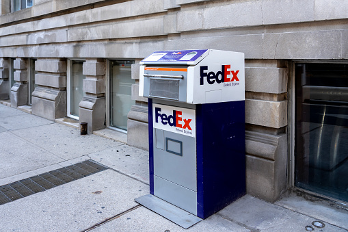 Toronto, Canada- November 14, 2020: A FedEx drop box on the street is shown in Toronto, Canada. FedEx Corporation is an American multinational delivery services company.
