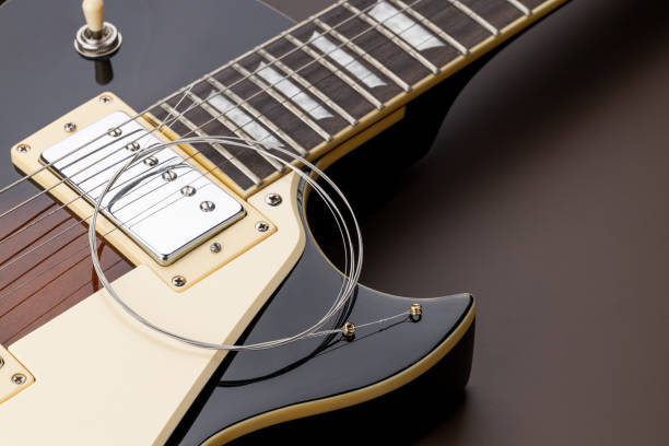 istock new music strings for electric guitar on a brown background. studio shot. space. restring concept. preparation to performance 1288493981