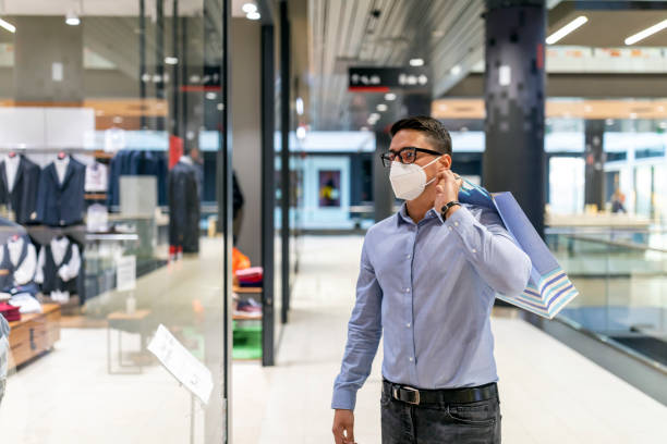 istock Young man wearing protective face mask and shopping 1288494103