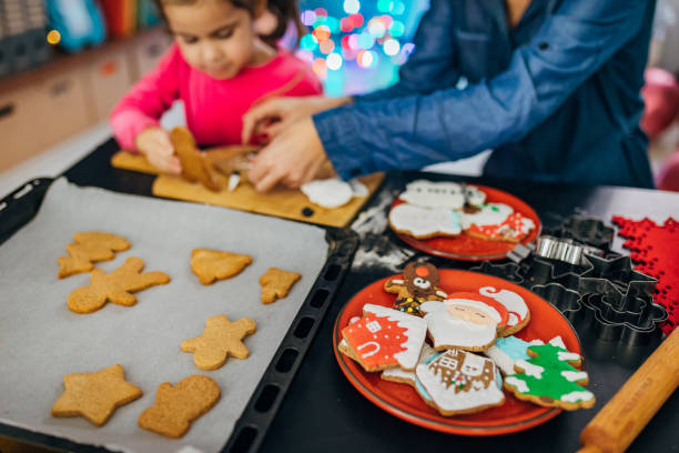 istock Mother and daughter bonding over gingerbread cookie decoration 1288497178