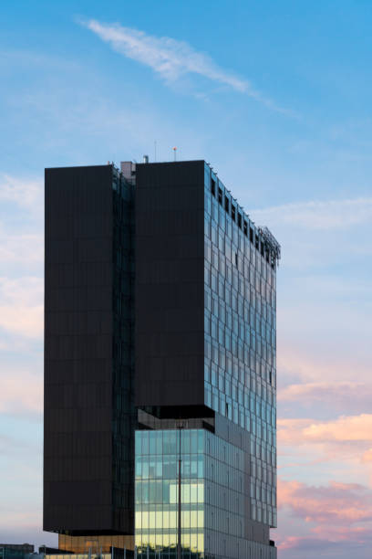 istock A modern office building at sunset with reflected sky and clouds 1288497504
