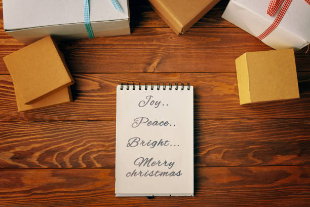 istock Top view of spiral notebook and gift boxes on wood table background. 1288498476