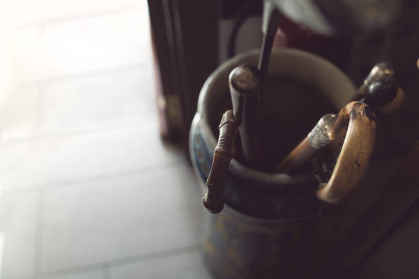 walking sticks stored in a clay umbrella stand