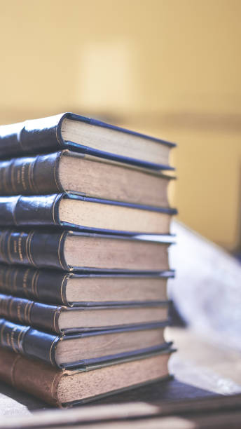 istock several old and slightly worn books stacked in a tower on a desk 1288501682