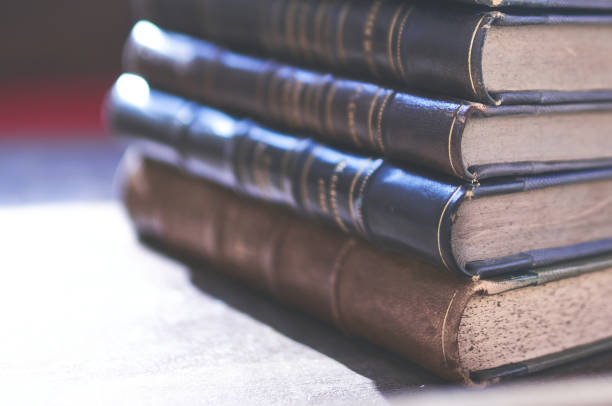 istock several old and slightly worn books stacked in a tower on a desk 1288501685
