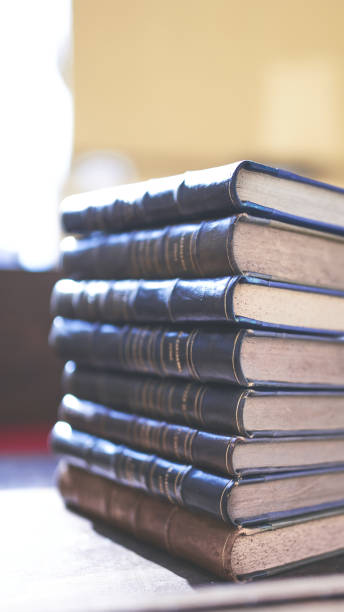 istock several old and slightly worn books stacked in a tower on a desk 1288501688