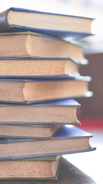 istock several old and slightly worn books stacked in a tower on a desk 1288502137