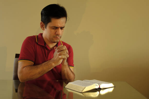 Man doing his prayer after reading the bible