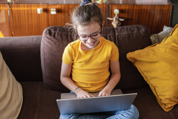 istock Little girl is using laptop at home 1288504717