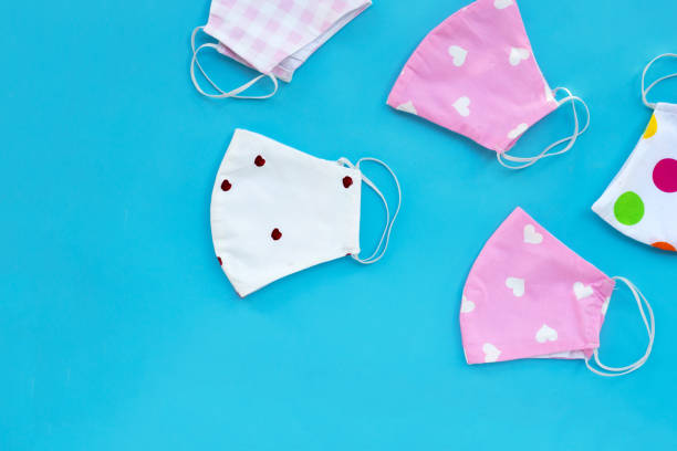 istock Handmade colorful cloth masks on blue background. 1288505953