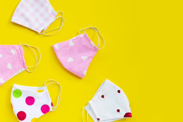 istock Handmade colorful cloth masks on yellow background. 1288505968