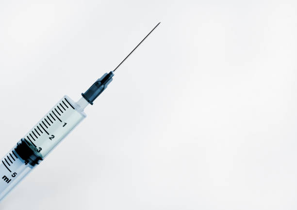Medical insulin syringe on white background. Macro view with copy space.