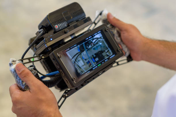 men's hands holding reference monitor