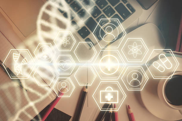 istock DNA hologram drawings over computer on the desktop background. Top view. Multi exposure. Concept medical education. 1288508109