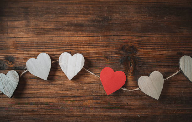 istock Heart shapes on wooden background. 1288509974