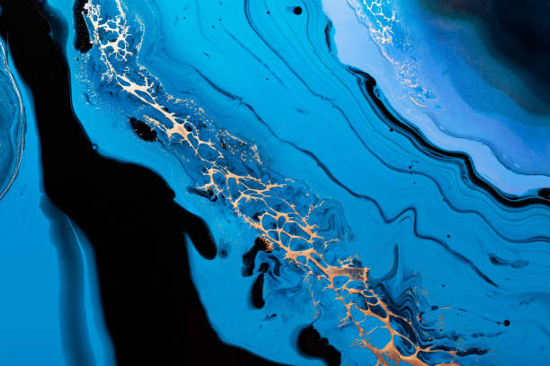 istock Fluid Art. Liquid Metallic Gold in abstract blue wave. Marble effect background or texture 1288510357