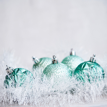 Christmas Background with Teal Green Ornaments and Tinsel