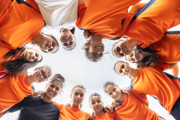 istock Low angle view of female soccer team looking at camera 1288513168