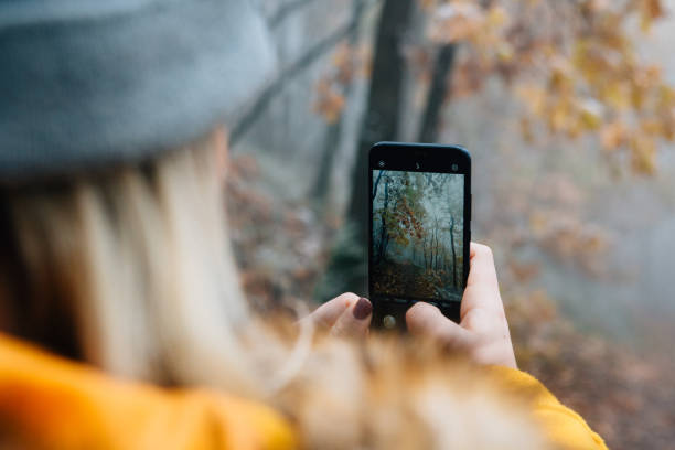 istock Woman taking pics with her phone hiking 1288513269