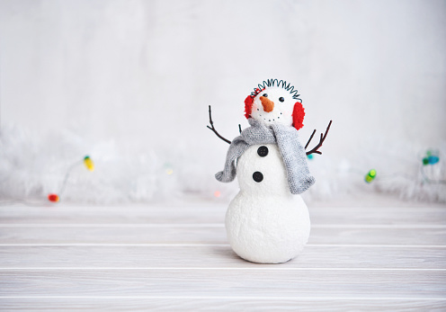 Snowman In Wintry Forest With Bokeh Lights
