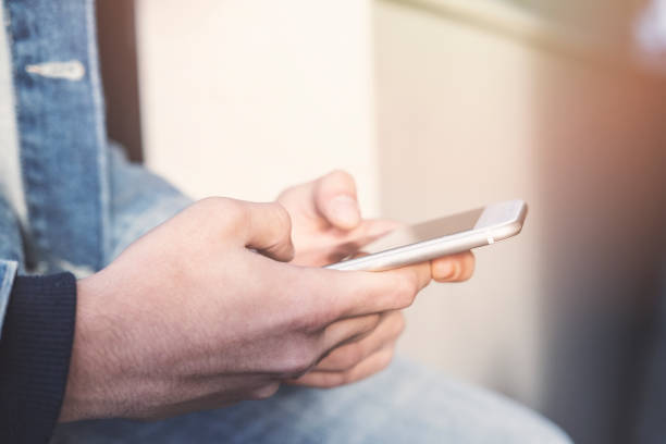 istock Teenage boy texting message in outside 1288514393