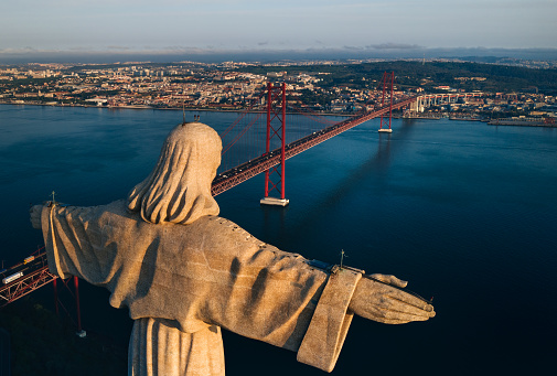 Aerial view of Sanctuary of Christ the King, Santuario de Cristo Rei. Drone photo at sunrise. Sightseeing in Portugal, Lisbon. High quality photo
