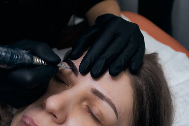 istock Permanent eyebrow makeup procedure. Eyebrow tattooing, process. The use of tools by a master for permanent eyebrow makeup. 1288520733