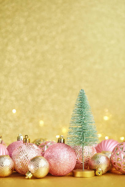istock Glittering Christmas Background with Pink and Gold Decorations and Christmas Tree 1288521642