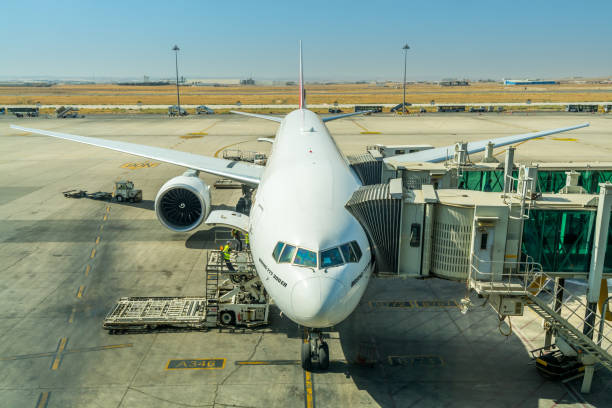 Airplane of Emirates airlines at the  boarding gate of Queen Alia International Airport (QAIA) in amman Jordan. stock photo
