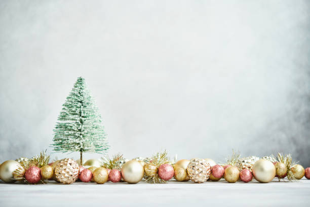 istock Glittering Christmas Background with Pink and Gold Decorations and Christmas Tree 1288524968