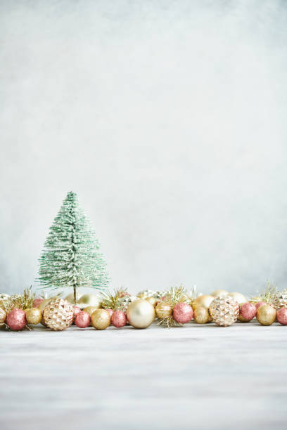 istock Glittering Christmas Background with Pink and Gold Decorations and Christmas Tree 1288525075