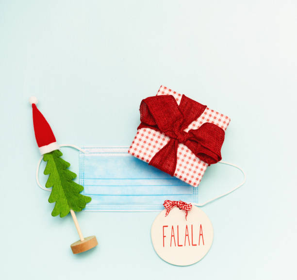 istock Christmas Flat Lay Background with Face Mask and Gift and Christmas Tree 1288527766