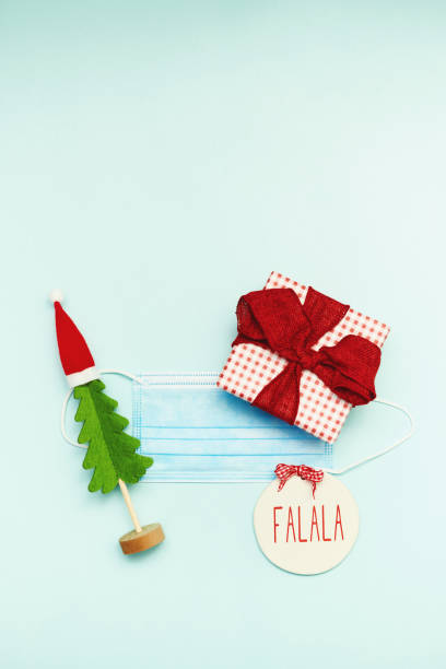 istock Christmas Flat Lay Background with Face Mask and Gift and Christmas Tree 1288527767