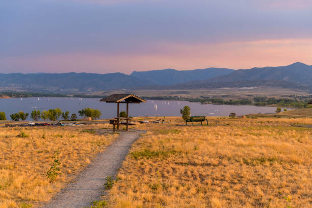 Sunset Summer Park - A Summer sunset view of a quiet picnic area at top of Chatfield Dam, Chatfield State Park, Denver-Littleton, Colorado, USA. A Summer sunset view of a quiet picnic area at top of Chatfield Dam, Chatfield State Park, Denver-Littleton, Colorado, USA. reservoir stock pictures, royalty-free photos & images
