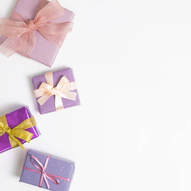 istock Purple color gift boxes on white background. flat lay, top view, copy space 1288539094