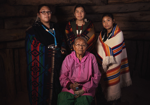 Calgary, Alberta, Canada. Jun 24, 2023. A medium shot of an indigenous woman talent showcase wearing a black traditional dress. National Indigenous Family Day and POW WOW. Aboriginal Awareness Week.