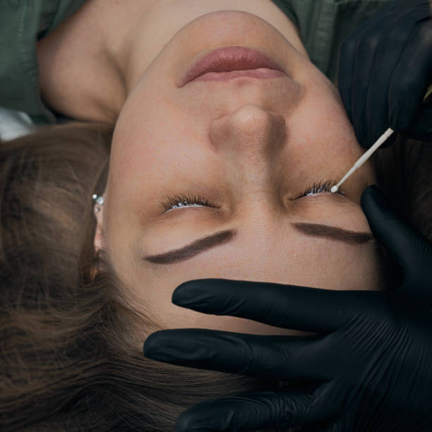 istock Permanent eyebrow makeup procedure. Eyebrow tattooing, process. The use of tools by a master for permanent eyebrow makeup. 1288543787
