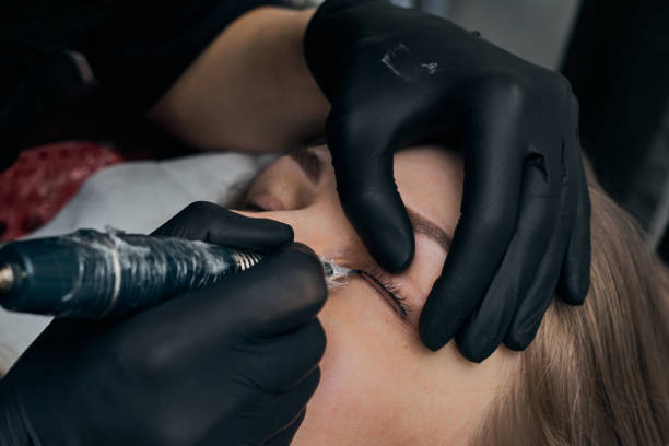 istock Permanent eyebrow makeup procedure. Eyebrow tattooing, process. The use of tools by a master for permanent eyebrow makeup. 1288543798
