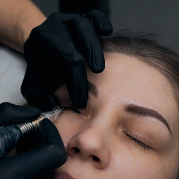 istock Permanent eyebrow makeup procedure. Eyebrow tattooing, process. The use of tools by a master for permanent eyebrow makeup. 1288543849