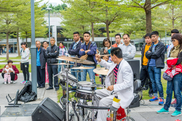 un drumer bianco di una band di strada locale di shenzhen che si esibisce nel parco centrale di shenhzhen, guangdong, cina - popular music concert outdoors central park people foto e immagini stock