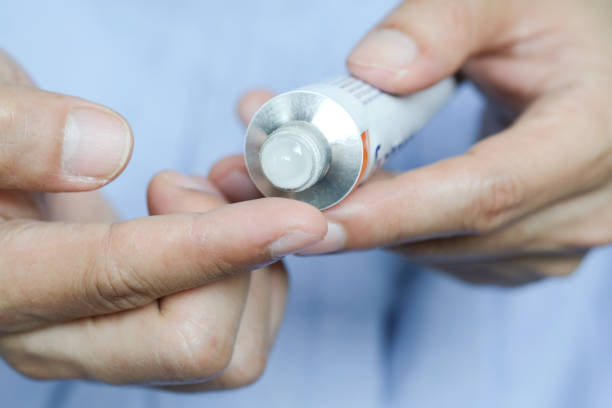 istock The woman's hand, she uses steroids Apply External type 1288545311